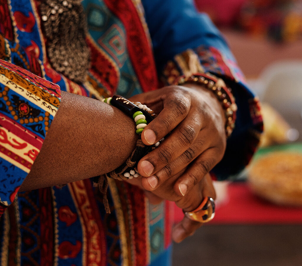Close up of beaded traditional African jewelry on an older woman's wrist